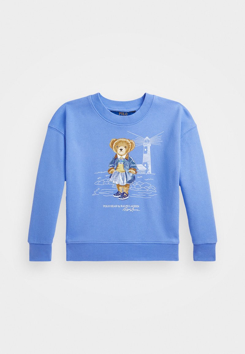 Blå sweatshirt med en björngrafik i en denimjacka och en rutig kjol. Ribbad mudd och nederkant, med broderad fyrdetalj i bakgrunden.