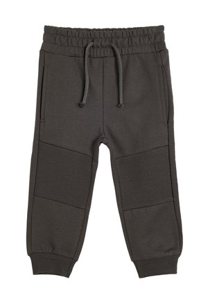 Pantalons de survêtement gris foncé avec taille élastique, cordon de serrage réglable, poches latérales et accents côtelés au niveau des genoux. Texture de tissu douce.