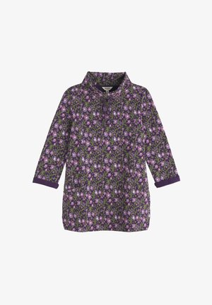 Virágmintás tunika sötétlila alapon, rózsaszín és zöld virágokkal. Hosszú ujjú és galléros nyakkivágással rendelkezik.