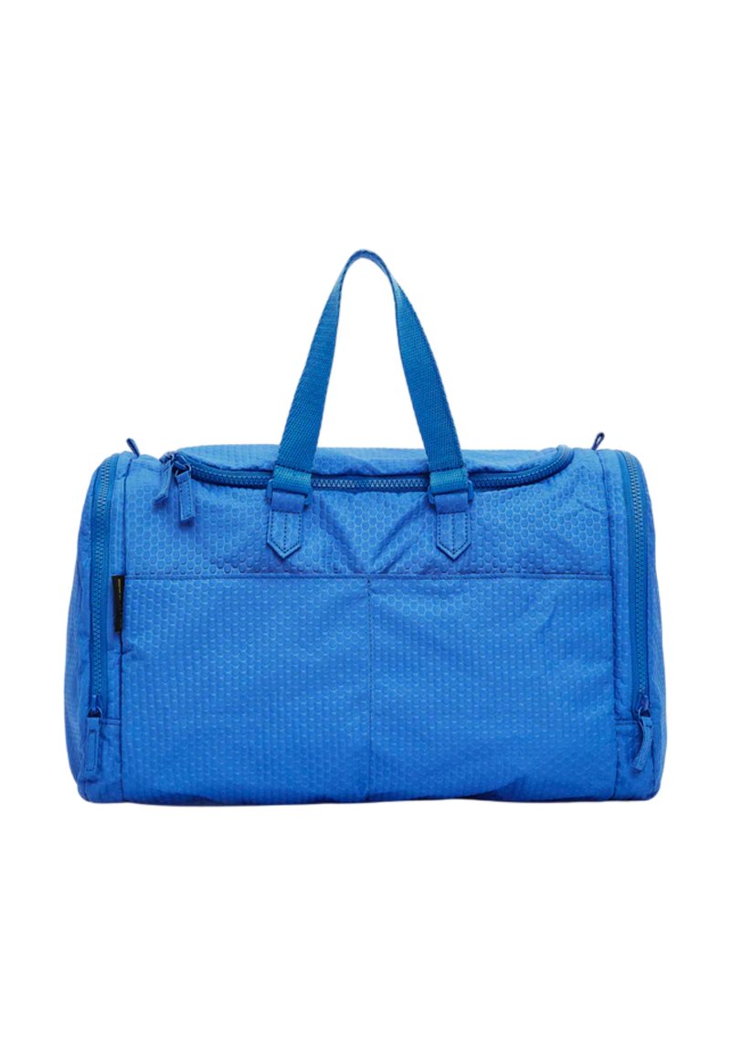 Sac de sport bleu en tissu texturé, doté de deux poignées supérieures et d'une fermeture éclair, avec deux poches latérales pour un rangement supplémentaire.
