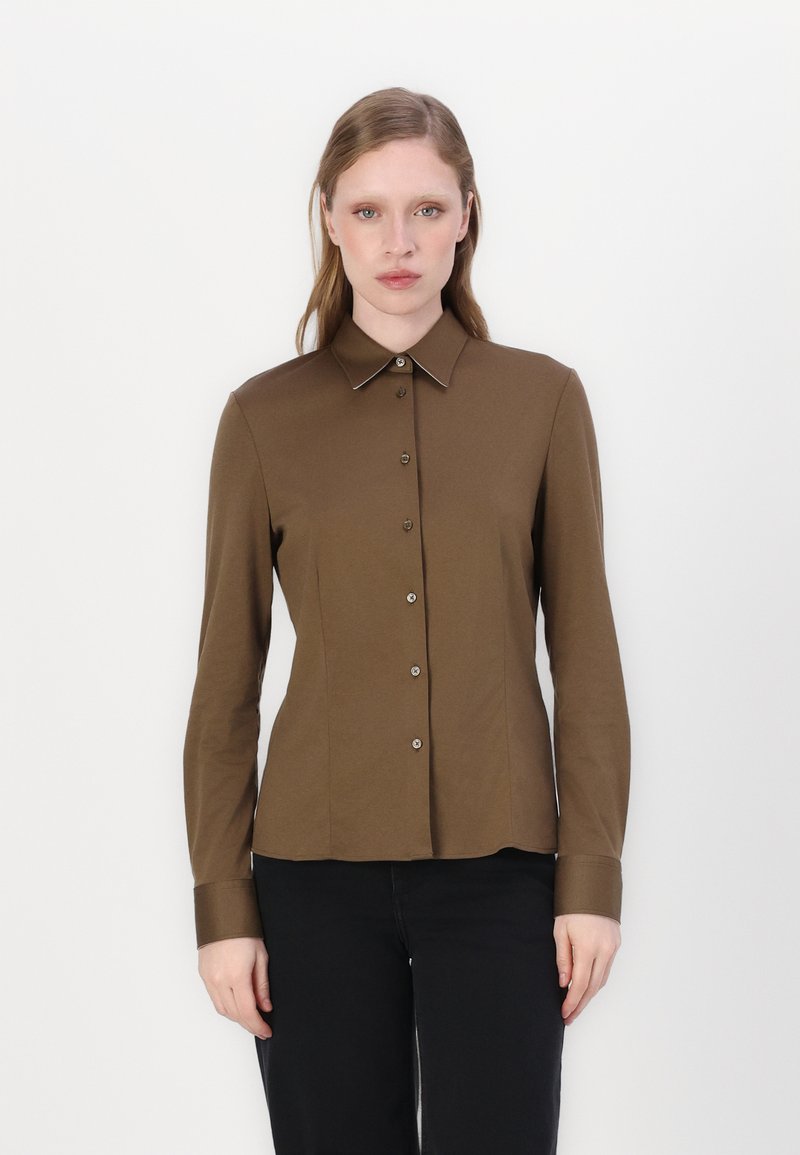 Brown long-sleeve shirt with a collared neckline, button-down front, and contrasting cuffs. Smooth fabric with a fitted design.