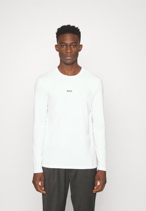 T-shirt blanc à manches longues avec un col rond et le logo noir "BOSS" au centre. Tissu doux, coupe ajustée, design minimaliste.