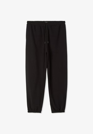 Pantaloni della tuta neri realizzati in tessuto morbido, con vita elasticizzata e coulisse, gambe con taglio affusolato e polsini elasticizzati, e tasche laterali.