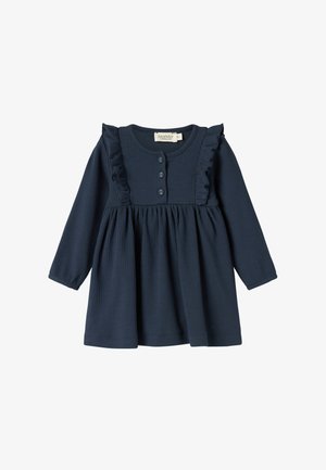 Tengerészkék, hosszú ujjú ruha fodros vállakkal és négy gombbal az elülső részen. Puha bordás textúrájú és fodros szoknyájú.