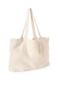 Grand sac fourre-tout de couleur crème, fabriqué en tissu doux, avec deux bretelles et un design simple et sans ornements. Surface texturée.