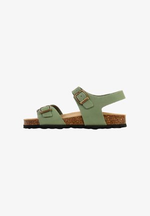 Grøn sandal med korksål og to justerbare remme med bronzespænder, sort tekstureret sål, sideprofil mod hvid baggrund.