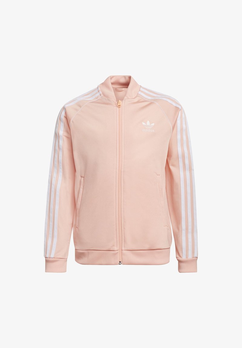 Chaqueta de cremallera rosa claro hecha de un tejido suave. Presenta tres líneas blancas en las mangas y un pequeño logo en el pecho. Puños acanalados.