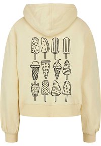 Kremkrāsas cropped hoodie ar melnu zīmējumu ilustrācijām par dažādām saldējuma un saldētas uzkodas formām uz muguras.