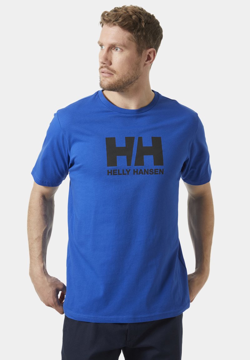 Camiseta de algodón azul con un logo negro "HH" y el texto "HELLEY HANSEN" en la parte frontal. Diseño clásico de cuello redondo y mangas cortas.