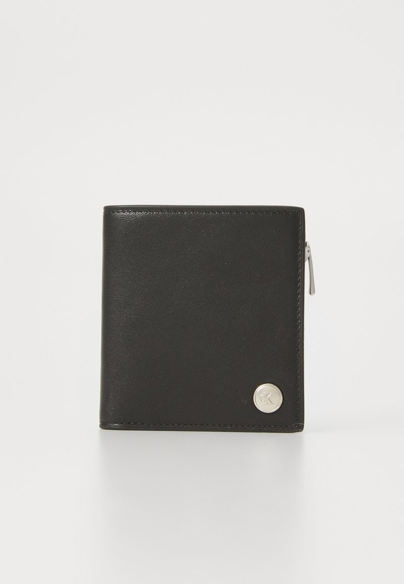 Black leather wallet with a smooth texture, bi-fold design, silver-tone hardware, and a circular logo accent on the front. Zippered section included.