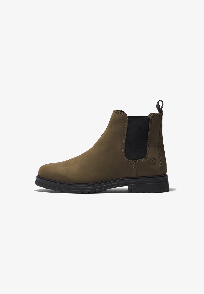 Bottes Chelsea en cuir marron avec panneaux latéraux élastiques, languette de tirage et semelle en caoutchouc noire. Présente une texture lisse et des coutures minimales.