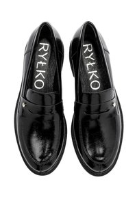 Black patent leather loafers with a smooth finish, featuring a raised seam and small metal accent; rounded toe and flat sole design.