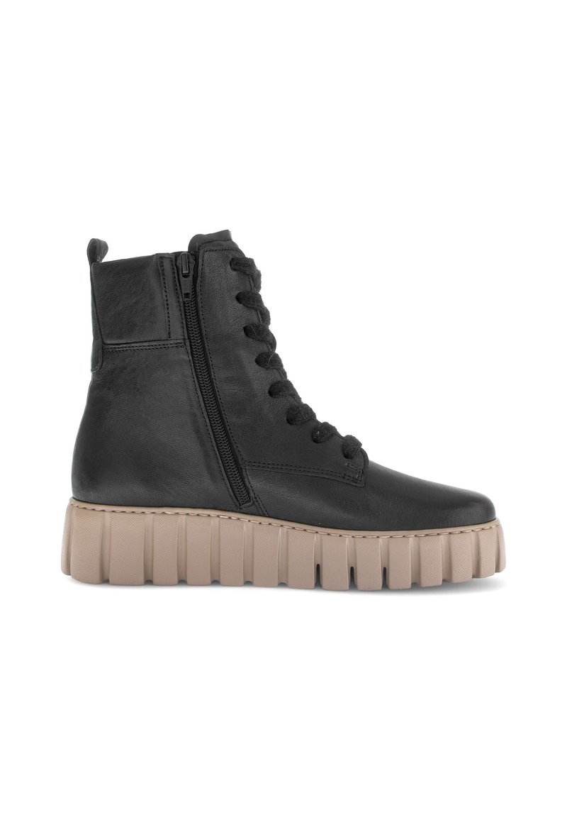 Black leather ankle boot with side zipper, laces, pull tab, and thick beige grooved sole.