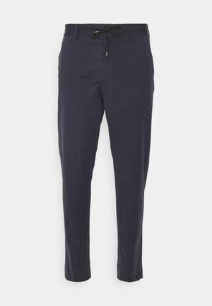 Marineblaue Hose mit Kordelzugbund, schmal zulaufenden Beinen und glattem Stoff. Hat eine einfarbige Ausführung ohne sichtbare Muster oder Hardware.