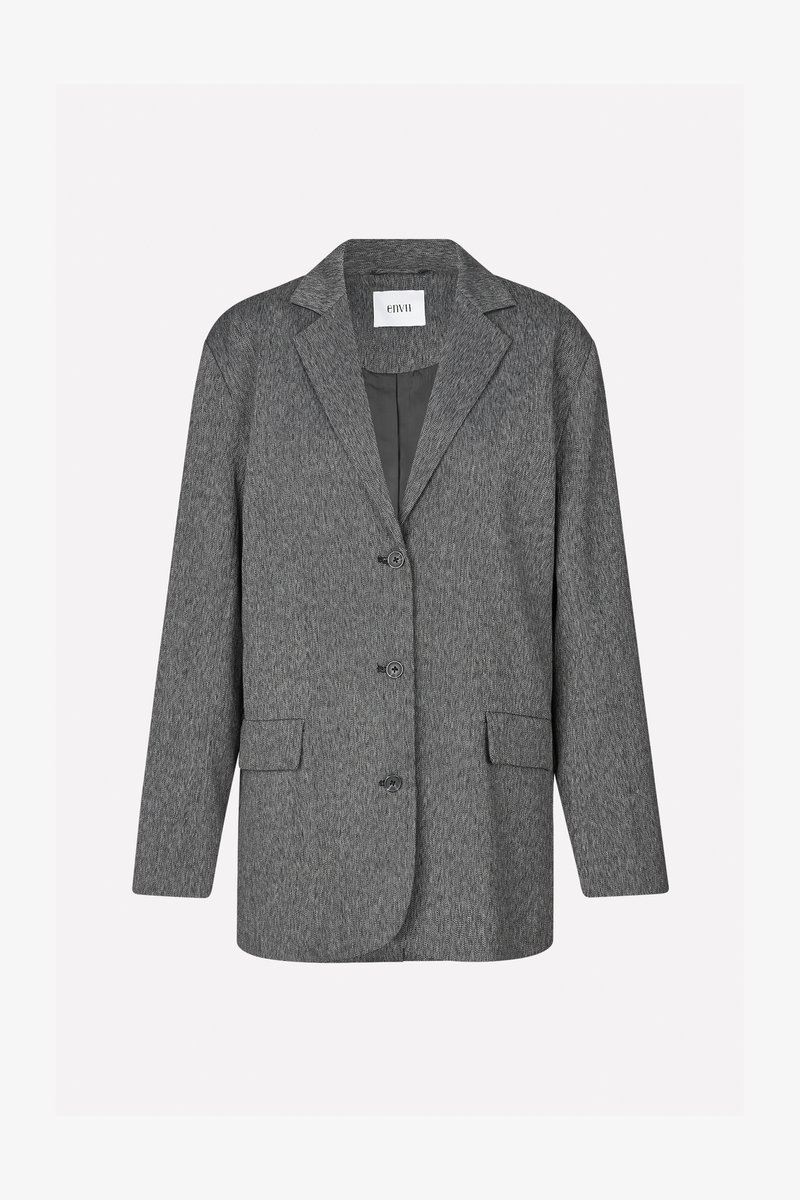 Blazer texturé gris avec un col cranté, trois boutons et deux poches avant. Fabriqué en tissu tissé avec une silhouette structurée.