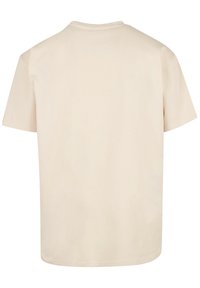 Short-sleeve, crew-neck t-shirt in a light beige color, made of soft cotton with a smooth texture, featuring a plain, unembellished design.