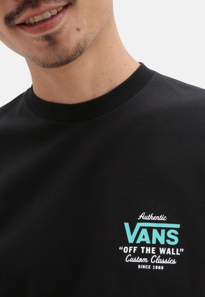 Schwarzes Baumwoll-T-Shirt mit einem VANS-Logo in aquablau und dem Text "Authentic OFF THE WALL Custom Classics Since 1966" in Weiß.