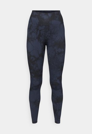 Tengerészkék leggings márványszerű fekete mintával, rugalmas anyagból készült, magas derékpánttal a kényelem és a tökéletes illeszkedés érdekében.