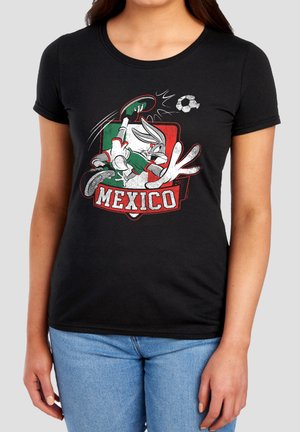 Black t-shirt with Bugs Bunny in Mexico soccer uniform kicking a ball over a green, white, and red Mexico flag background.