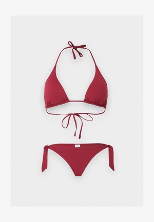Red triangle bikini set with halter neck and tie closures at neck, back, and sides of the bottoms on a plain light background.
