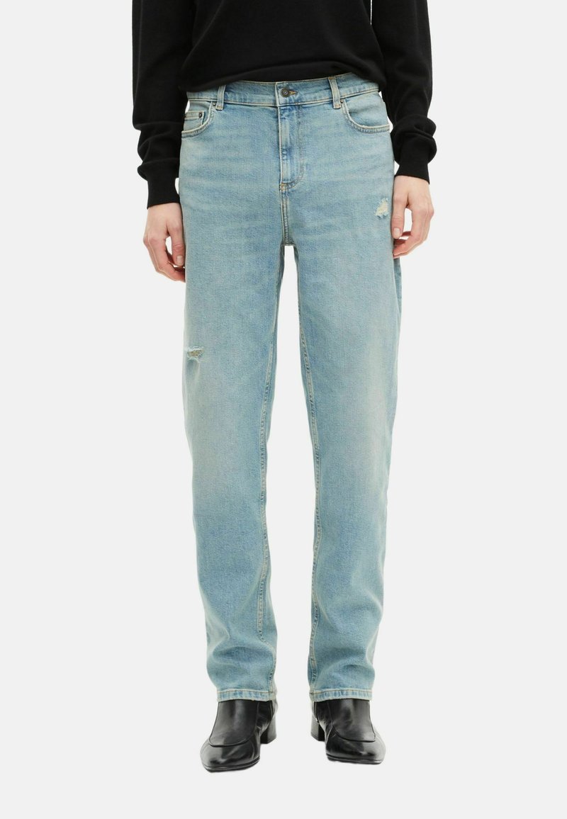 Light blue denim jeans with a relaxed fit and slight distressing at the knees. Features five pockets and a button closure.