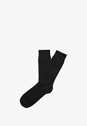 Schwarze Baumwollsocken mit glatter Textur, knöchelhoch, mit geripptem Bund, ohne Muster oder sichtbare Marken.