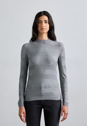 Long-sleeve top made of metallic gray fabric, featuring a high neckline and horizontal striping design across the torso and sleeves.