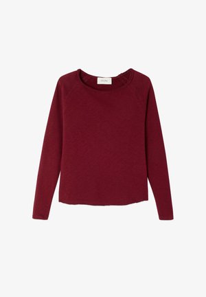 Bordo pikkade varrukatega särk ümarate kaelustega. Valmistatud pehmest, tekstuuriga kangast; omab raglan-varrukaid ja sirget lõiget äärtes.