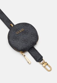 Pyöreä musta nahkainen kolikoita varten suunniteltu kukkaro, jossa on kohokuvioitu kuosi. Varustettu kultaisilla yksityiskohdilla, vetoketjukiinnitys sekä irrotettava hihna käytön mukavuuden vuoksi.