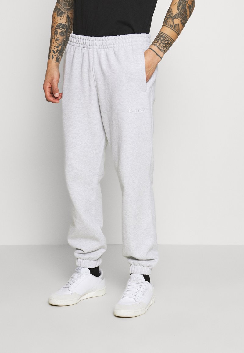 adidas Originals BASICS UNISEX Tracksuit bottoms light/light yellow