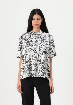 Short-sleeve button-up shirt in black and white abstract print. Lightweight fabric, collar detail, and patch pocket on the left side.