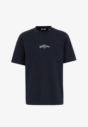 Tricou din bumbac bleumarin, cu o croială lejeră, mâneci scurte, guler rotund și text imprimat alb care spune „L’ÉTÉ EN VILLE” pe față.