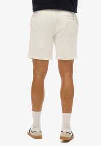 Superdry & Co EMBOSSED - Pantalon de survêtement - new chalk white