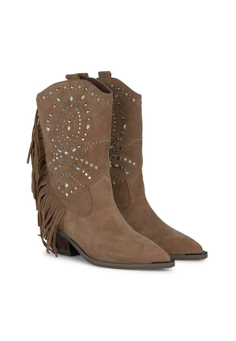 Bruine suède cowboylaarzen met spitse neuzen, franjes en decoratieve studs in verschillende vormen en maten over de schacht.