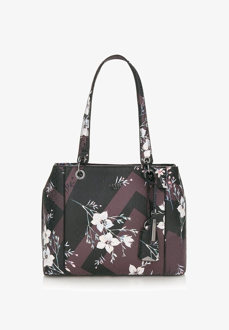 Sac cabas Guess noir et violet foncé avec imprimé floral blanc, doubles anses d'épaule et détail d'étiquette suspendue.