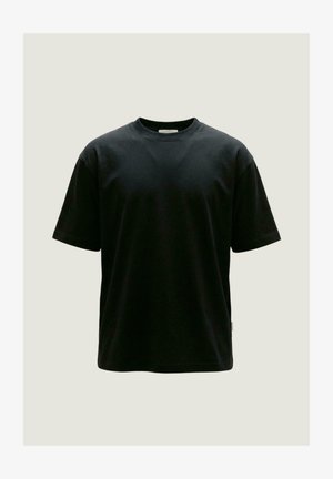 T-shirt nera in cotone a maniche corte con scollo tondo, mostrata su uno sfondo chiaro e neutro.