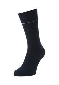 Calcetín de algodón navy con textura acanalada, diseño de color sólido y un acento en azul claro en la parte superior. Marca a juego cerca del área del tobillo.
