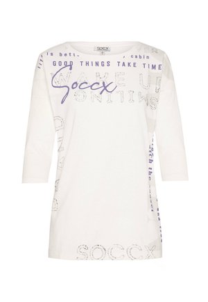 White long-sleeve t-shirt with purple text and silver studded details. Features a round neckline and relaxed fit with various phrases.