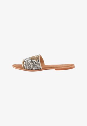 Flat slide sandals featuring a beaded strap in gold, silver, and white with a brown leather sole. Simple shape with open toe design.