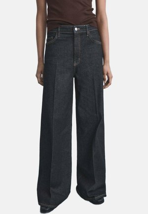 Wide-leg dark denim jeans with a high waist, featuring contrasting yellow stitching, side pockets, and a button closure.