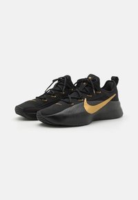 Black athletic shoes with a textured upper, featuring gold accents, laces, and a rubber sole with a patterned design.