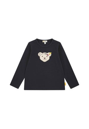 Langärmliges navy Shirt mit einem Bärenkopf-Applikation, Sternen und einem gelben Akzent. Weicher Baumwollstoff mit rundem Ausschnitt.