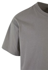 Gray cotton T-shirt with a round neckline, short sleeves, and a smooth texture. Stitching detail visible on the sleeves.