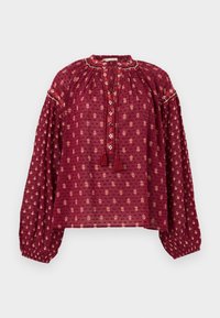 Blouse à manches longues couleur bordeaux avec petits motifs floraux, col froncé, liens avec pompons boutonnés et poignets élastiques.