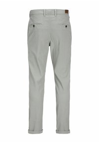 Light grey trousers with a textured fabric, featuring double back pockets and rolled cuffs for added detail. Brown leather patch at waistband.