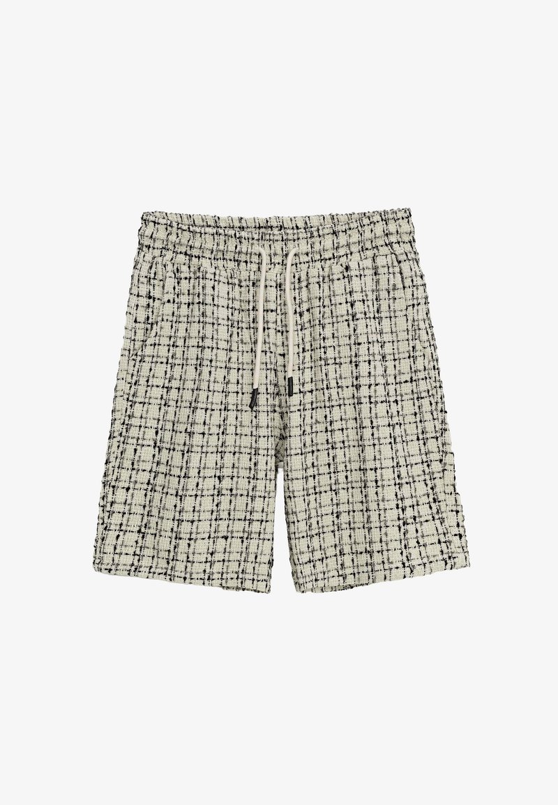 Shorts à carreaux noirs et blancs avec une taille élastique et un cordon de serrage, dotés d'un tissu texturé et d'une coupe décontractée.