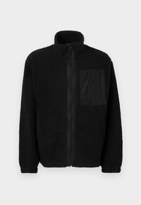 Schwarze Fleecejacke mit hohem Kragen, vollem Frontreißverschluss und einer Brusttasche aus glattem Stoff. Strukturiert äußere Oberfläche.