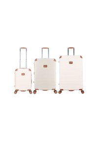 Three cream-colored hard-shell suitcases with brown handles and wheels, arranged from small to large, each with an extended telescopic handle.