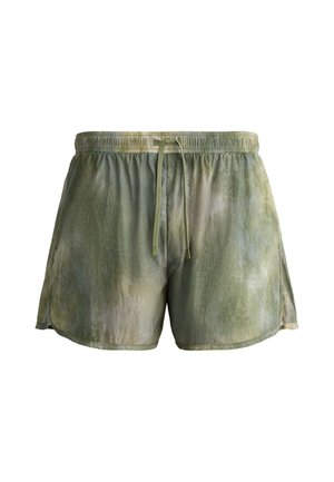 Shorts homme à cordon de serrage, coupe ample, motif tie-dye vert et gris avec fentes latérales sur chaque jambe.