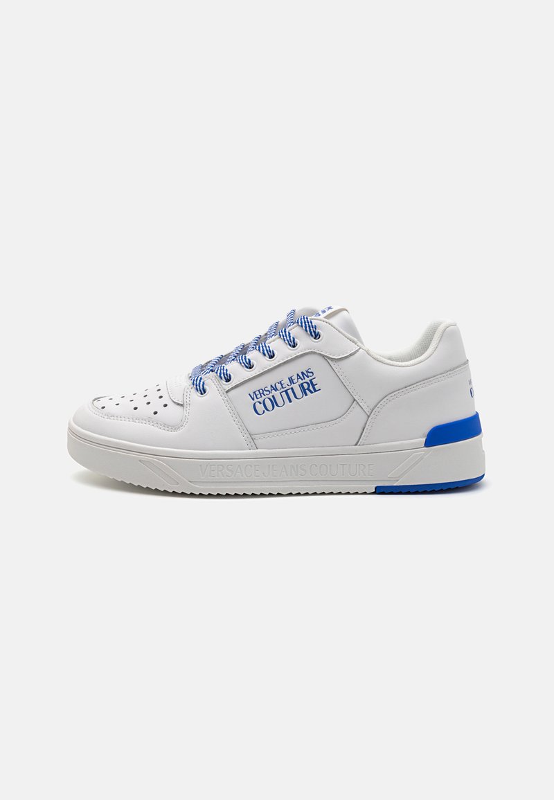 White leather sneaker with blue accents, perforated toe, and textured sole. Features blue laces and brand logo on the side.